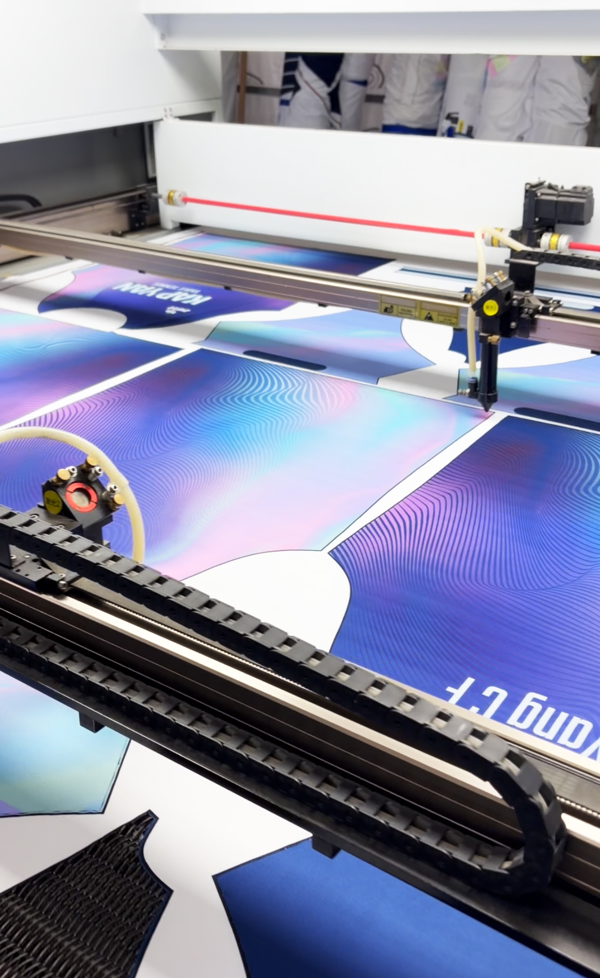 aser cutting machine precisely cutting polyester fabric panels for custom sportswear