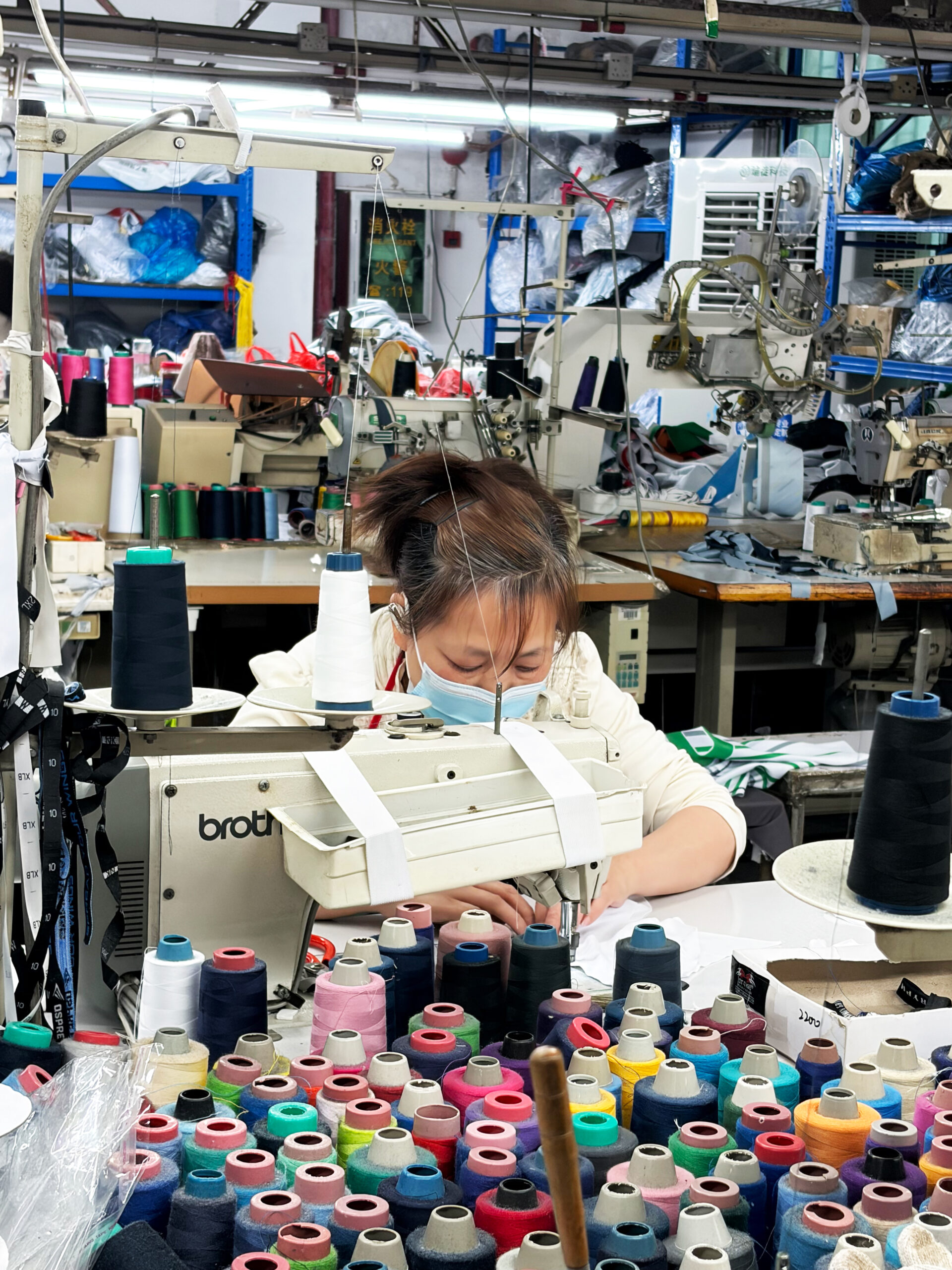 Professional sportswear factory with flatlock sewing machines producing athletic apparel
